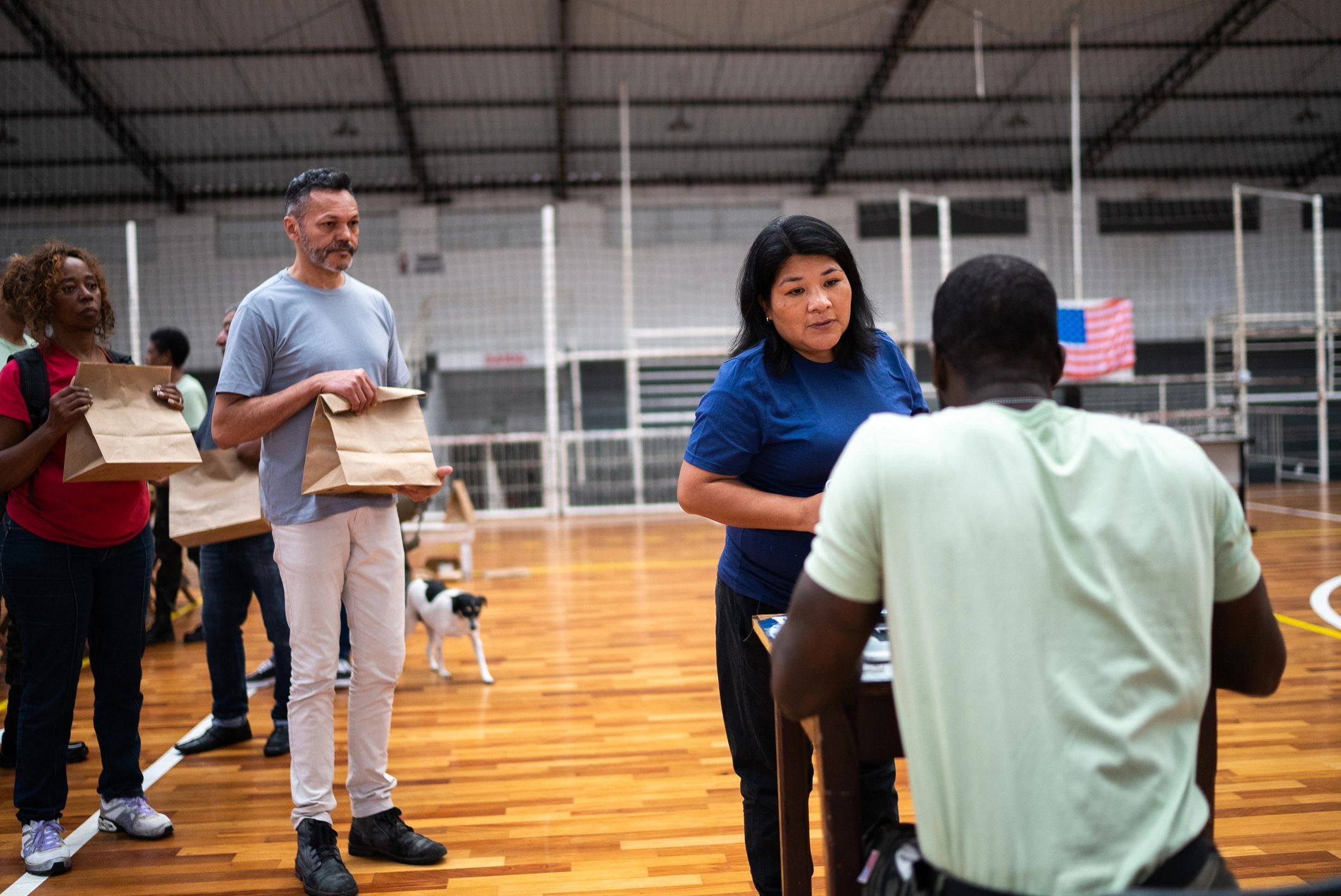 Protection personnel assisting a displaced civilian with documentation at a refugee shelter
