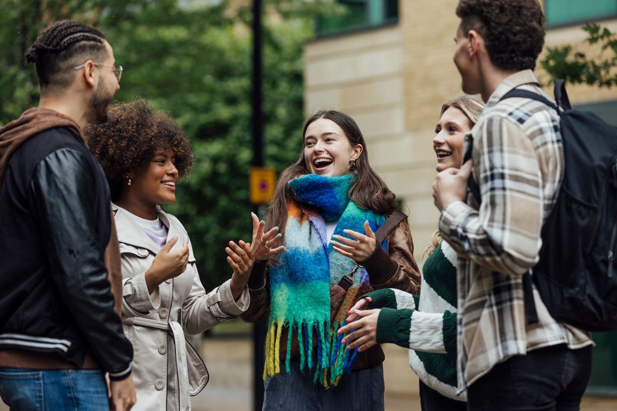 Young people in conversation in an urban community setting