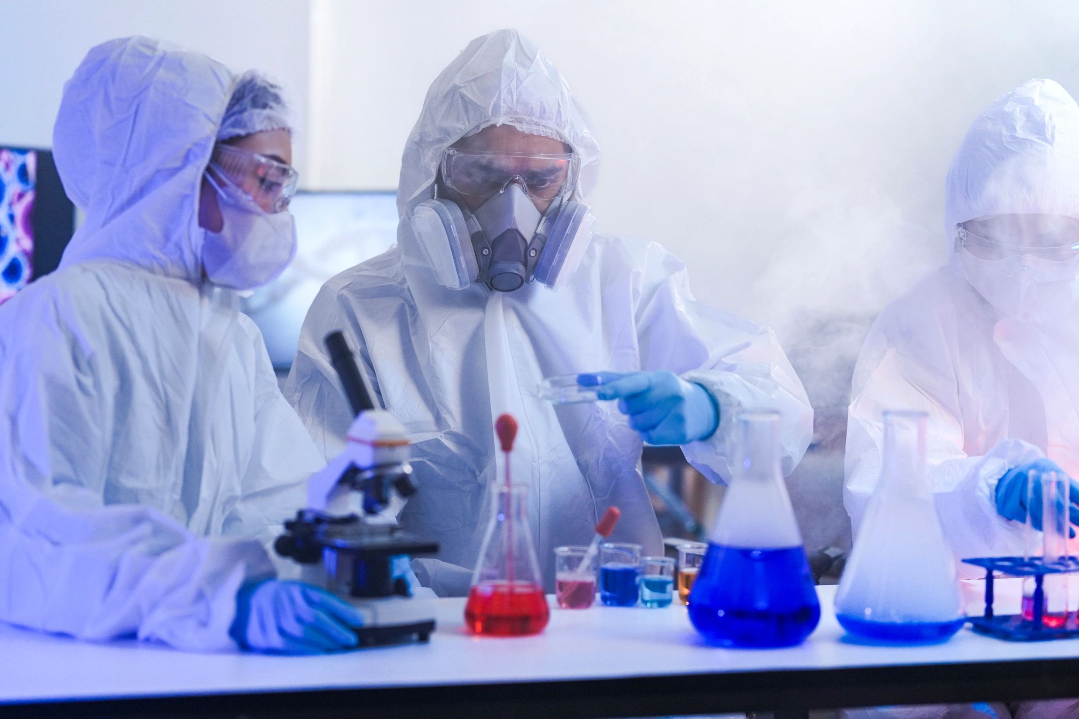 Scientists in hazmat suits operating in a high-security laboratory