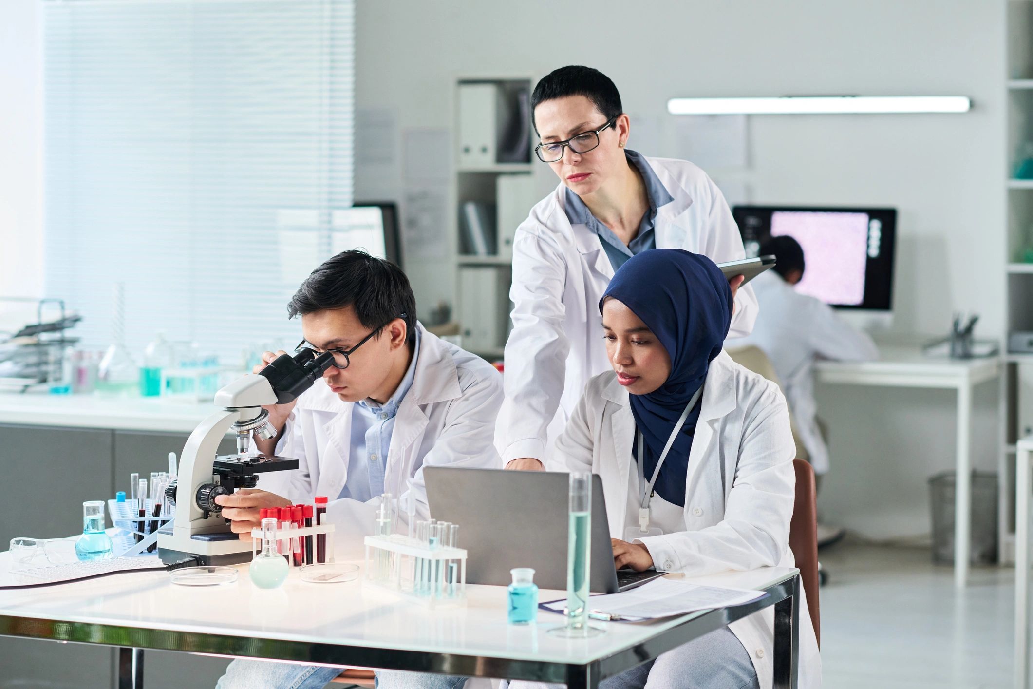 Scientists collaborating in a laboratory on biosurveillance research