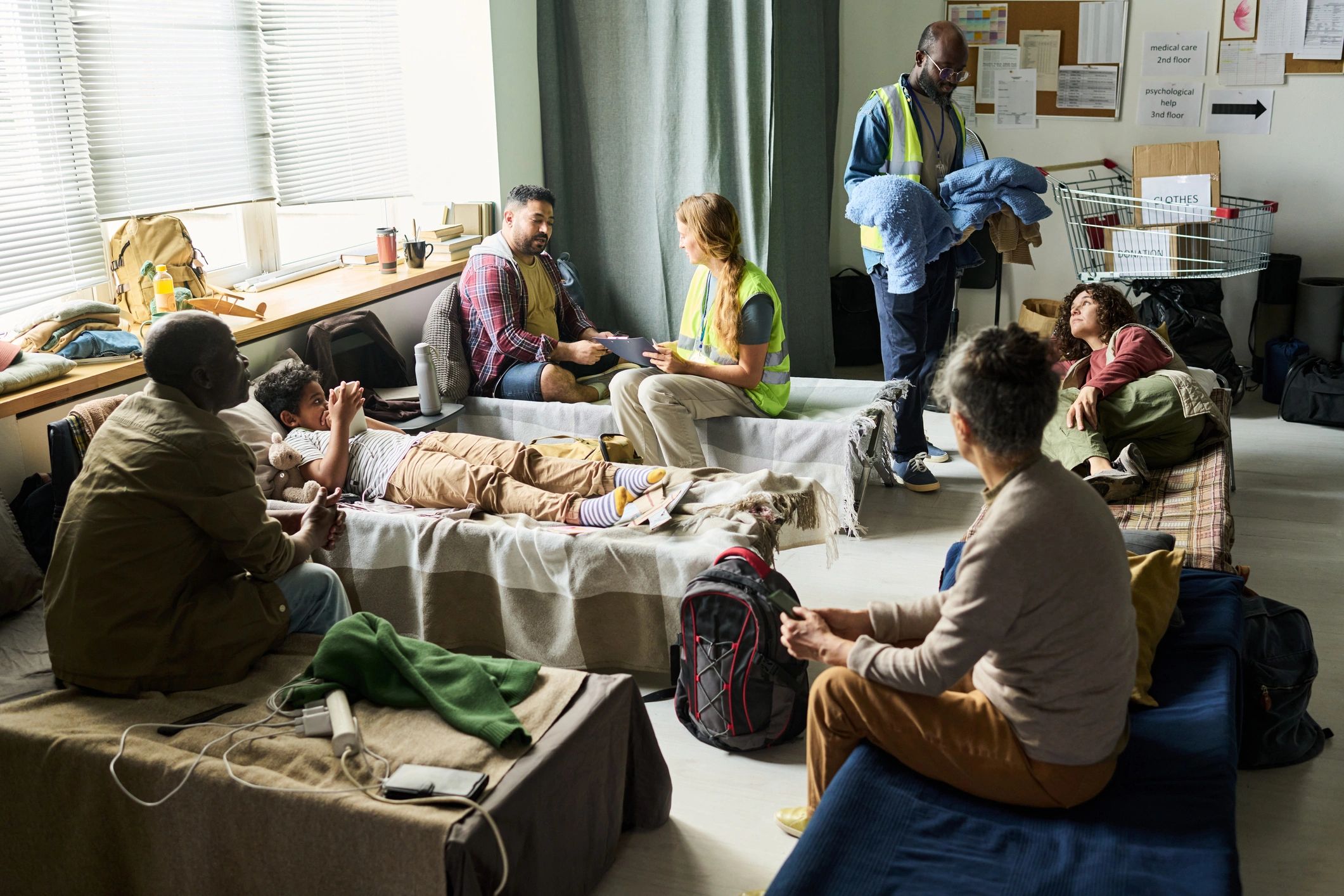 Aid workers supporting families in an emergency shelter