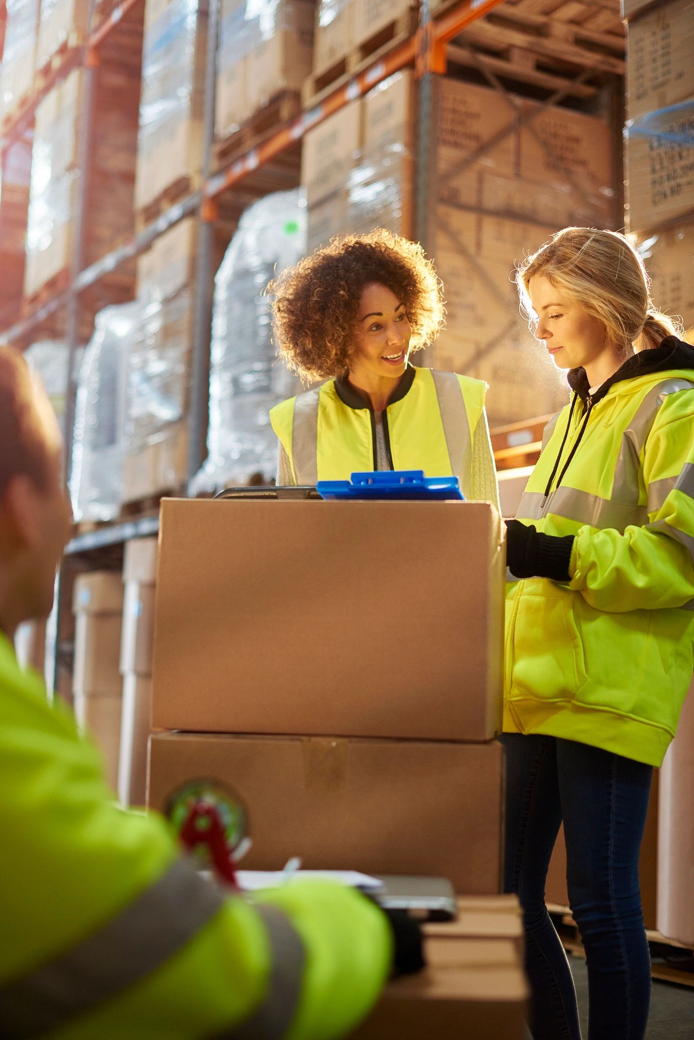 Field coordination staff reviewing logistics documents in a warehouse setting